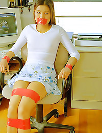 Slim teen taped to a chair
